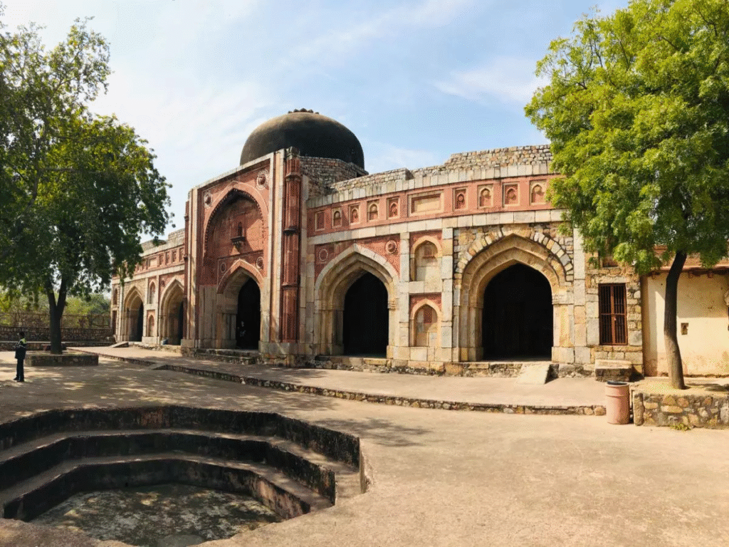 Jamali Kamali Mosque and Tomb complex in Delhi, showcasing Mughal architecture set in a serene garden.

