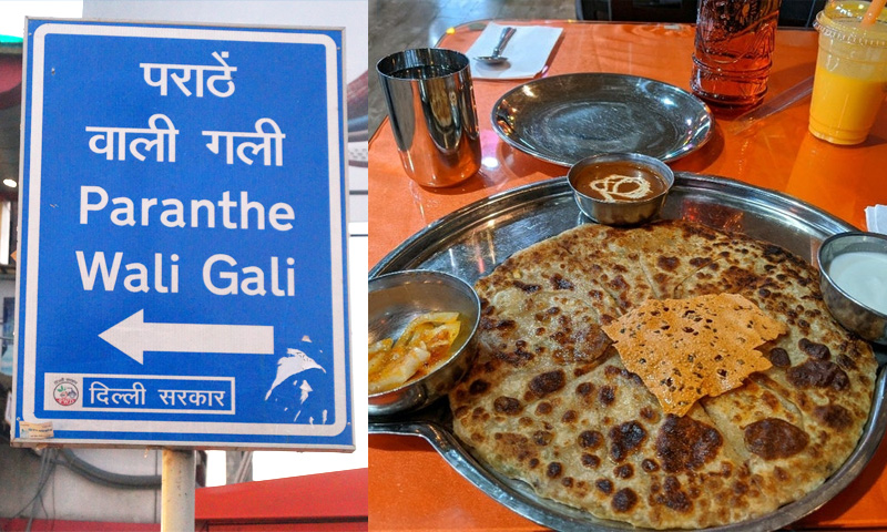 Signboard reading "Paranthe Wali Gali" in vibrant colors, welcoming visitors to Old Delhi's famous paratha street.


