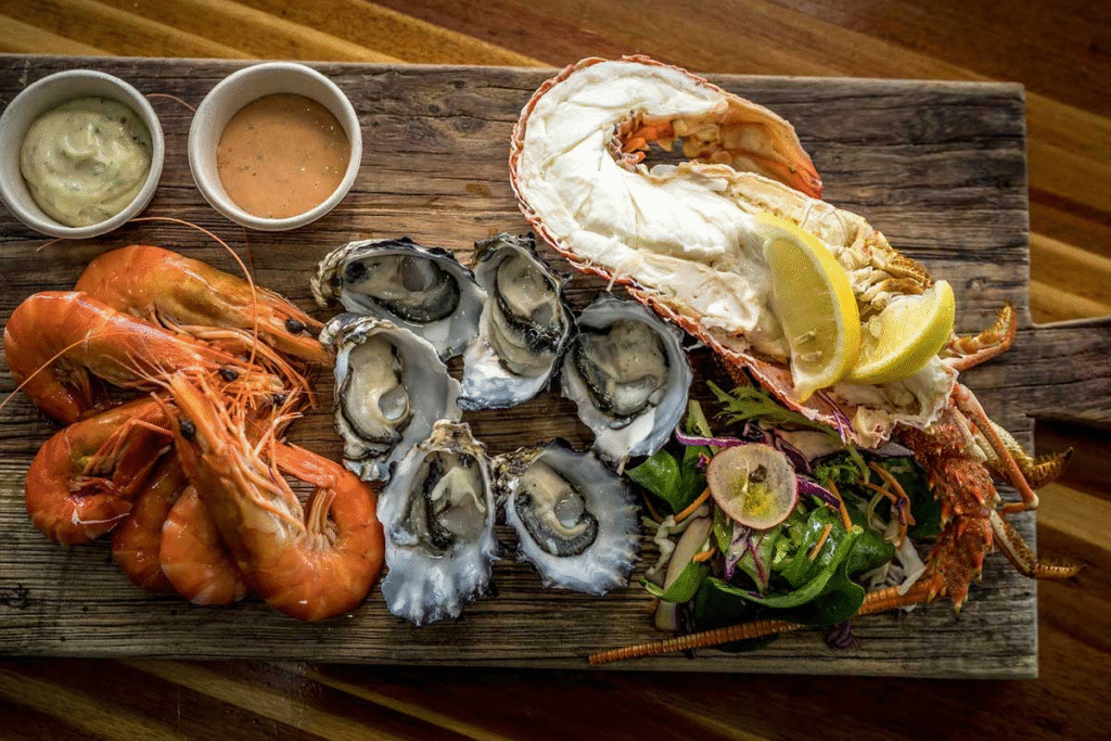 Fresh seafood platter featuring fish, mussels, and lobster served at a coastal restaurant in the Islands