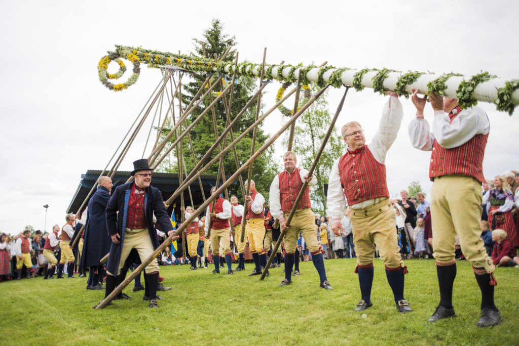 Traditional dancers performing at a lively Nordic cultural festival with colorful costumes and festive decorations