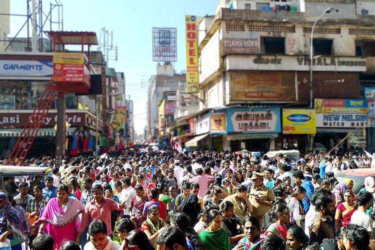 Shops and vendors lining Pondy Bazaar in Chennai with a variety of clothing, electronics, and accessories.

