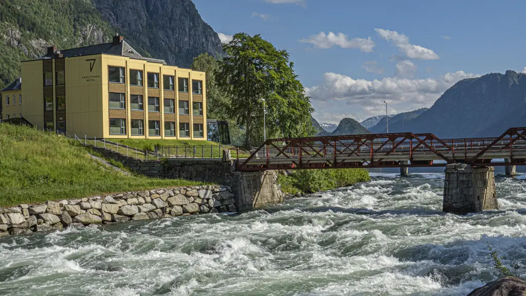 Stunning river view near the Trolltunga hotel, with crystal-clear waters flowing through lush green valleys.