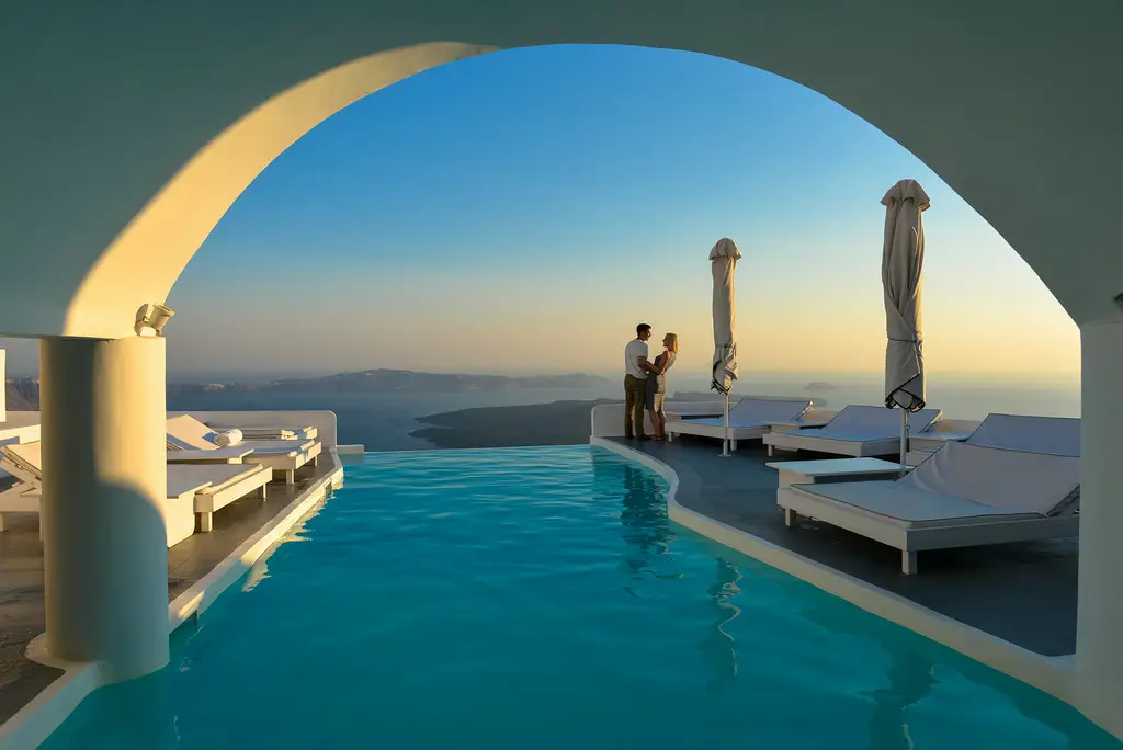 Romantic couple enjoying sunset views in Santorini, Greece on honeymoon
