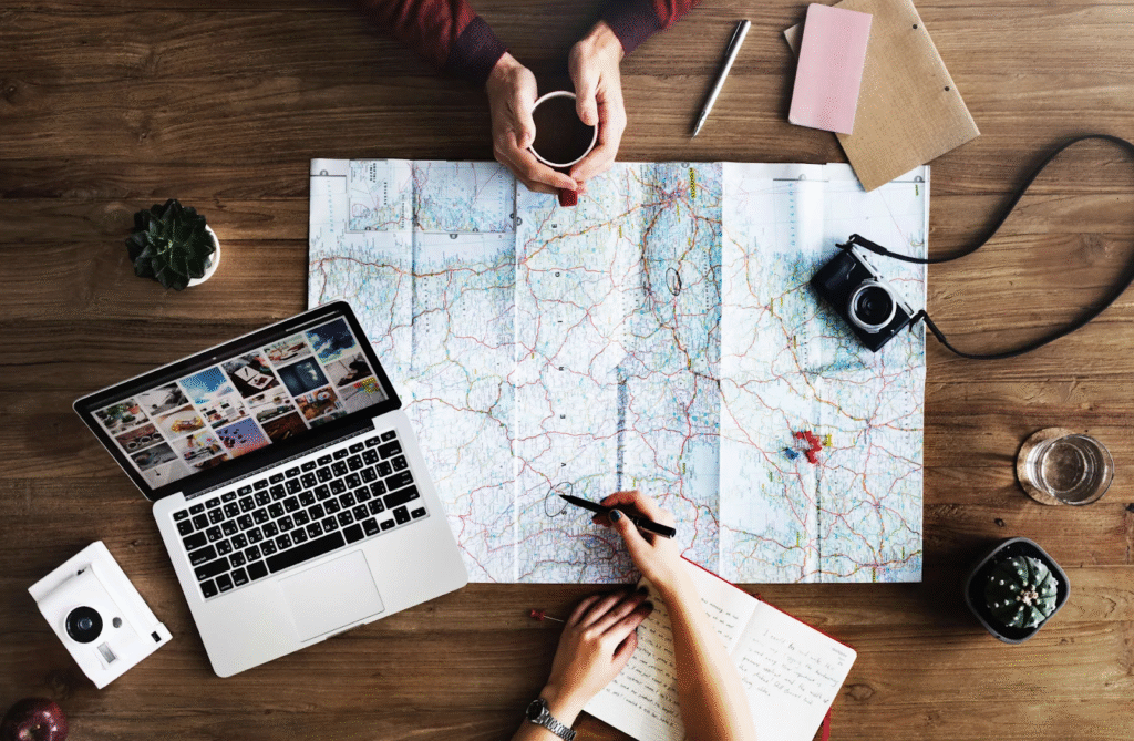 "Calendar, passport, and travel guide on a wooden table"

