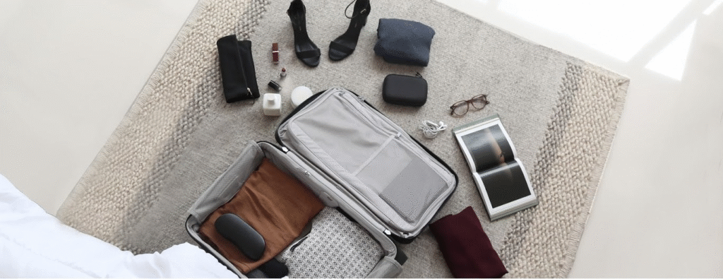 Compact travel bag with neatly folded clothes, packing cubes, and essential items arranged for light travel.